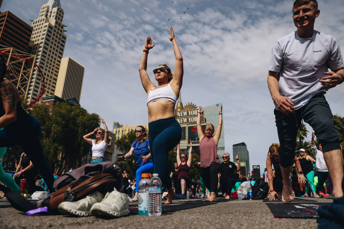 People gather on the Strip to do yoga while it is shut down for the Rock ’n’ Roll ...