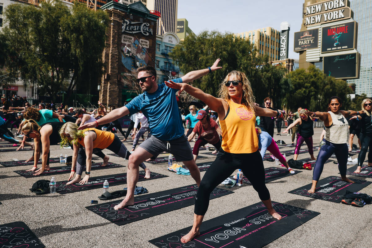 People gather on the Strip to do yoga while it is shut down for the Rock ’n’ Roll ...