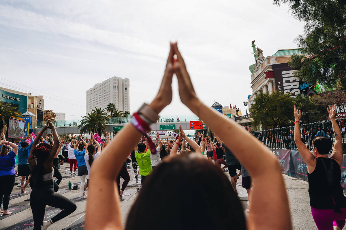 People gather on the Strip to do yoga while it is shut down for the Rock ’n’ Roll ...