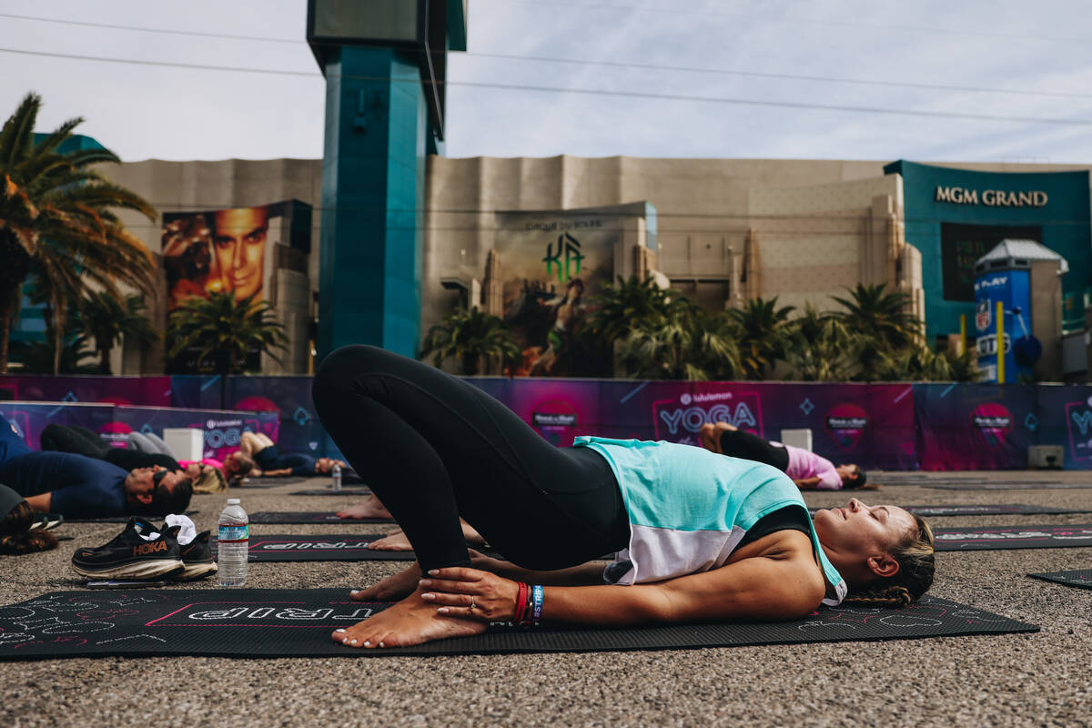 People gather on the Strip to do yoga while it is shut down for the Rock ’n’ Roll ...