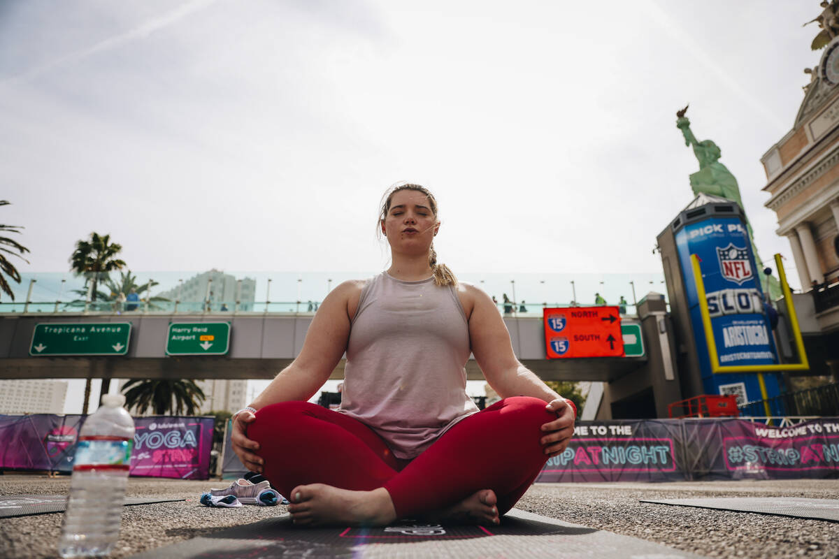 A person does yoga on the Strip while it is shut down for the Rock ’n’ Roll Running Series ...
