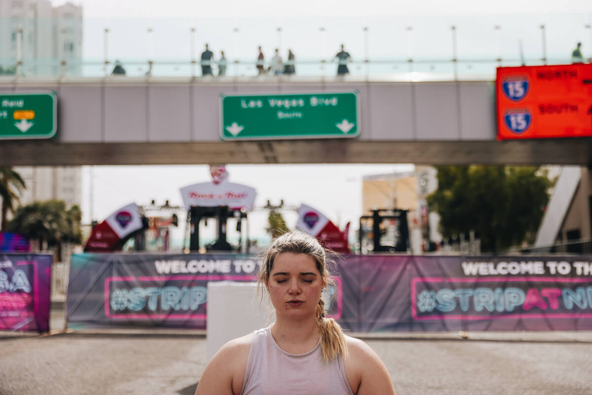 A person does yoga on the Strip while it is shut down for the Rock ’n’ Roll Runni ...