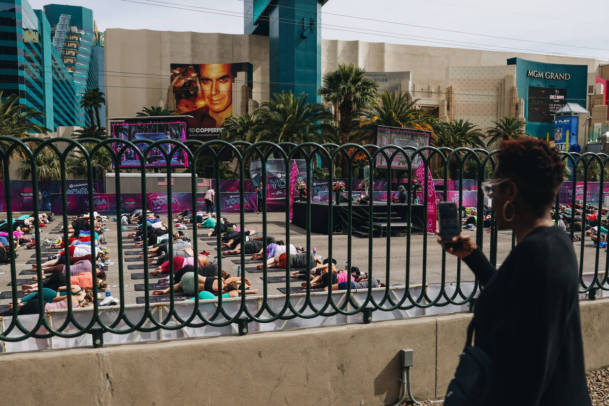 People gather on the Strip to do yoga while it is shut down for the Rock ’n’ Roll ...
