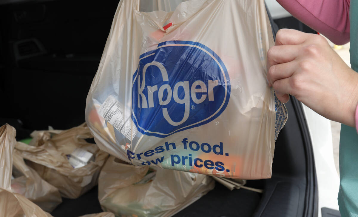 FILE - A customer removes her purchases at a Kroger grocery store in Flowood, Miss., Wednesday, ...