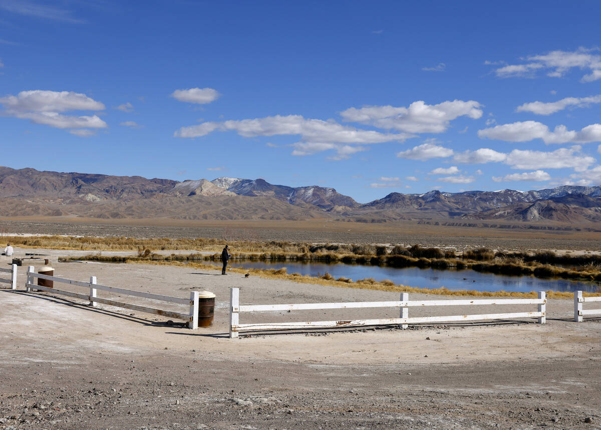 A woman stands at a pond formed from an old oil well project near the Rhyolite Ridge lithium-bo ...