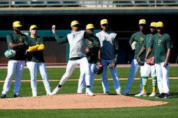 Oakland Athletics players run drills during a baseball spring training workout, Friday, Feb. 16 ...