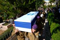 Israeli soldiers carry the casket of Staff sergeant Narya Belete during his funeral in Netanya, ...
