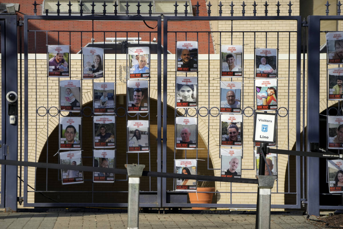 Posters of kidnapped people line the gates at the entrance of the Israeli Embassy, Monday, Feb. ...