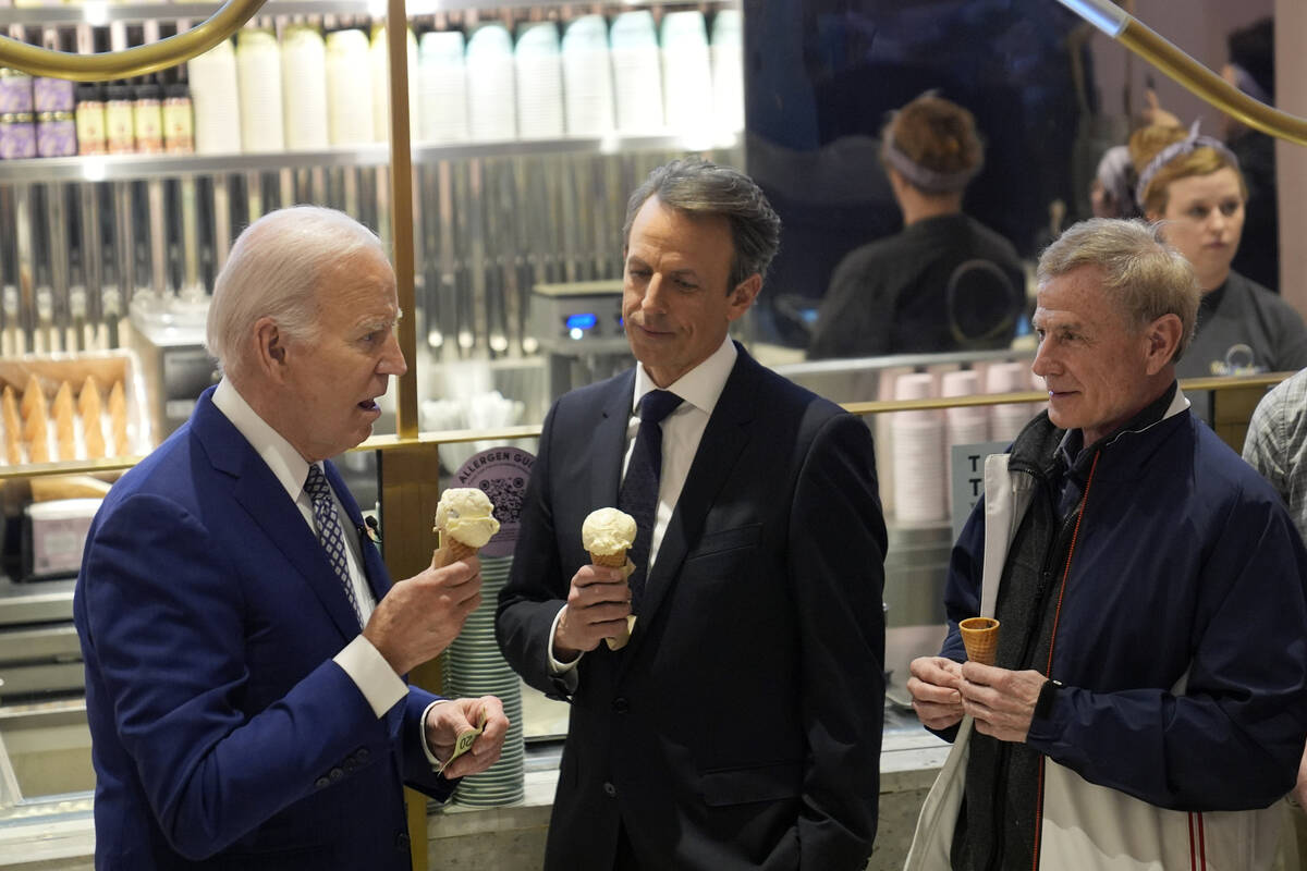 President Joe Biden talks with Seth Meyers, center, as he visits Van Leeuwen Ice Cream Monday, ...