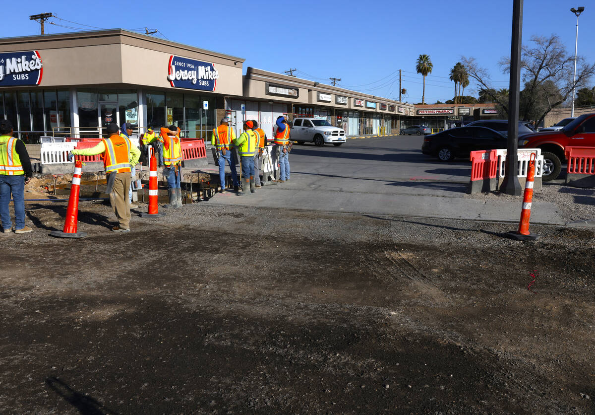 Road construction is underway near a shopping plaza at Charleston Boulevard and Rancho Drive in ...