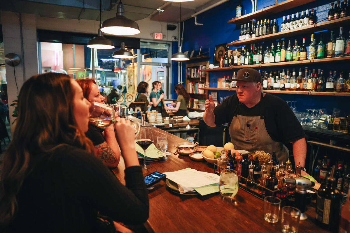 Esther’s Kitchen chef and owner James Trees speaks to people at the bar at Esther&#x2019 ...