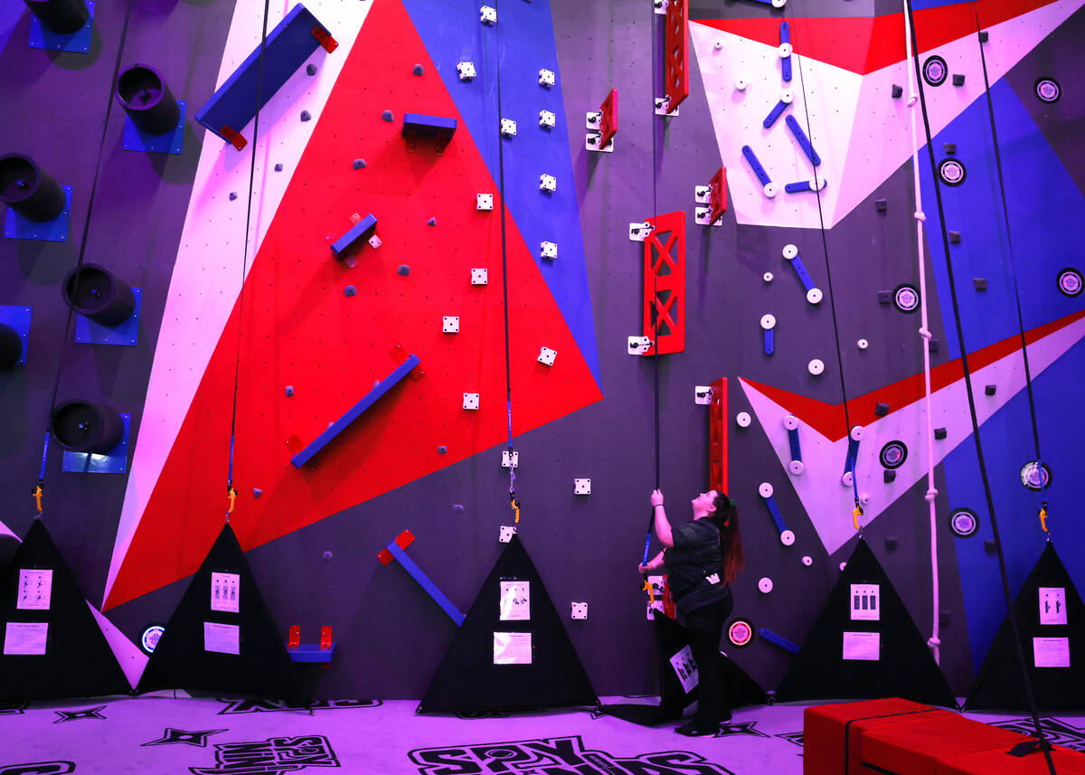 Reina Ochoa, an attraction agent, inspects Chad's Wild Climb's belays at Spy Ninja HQ, the Worl ...