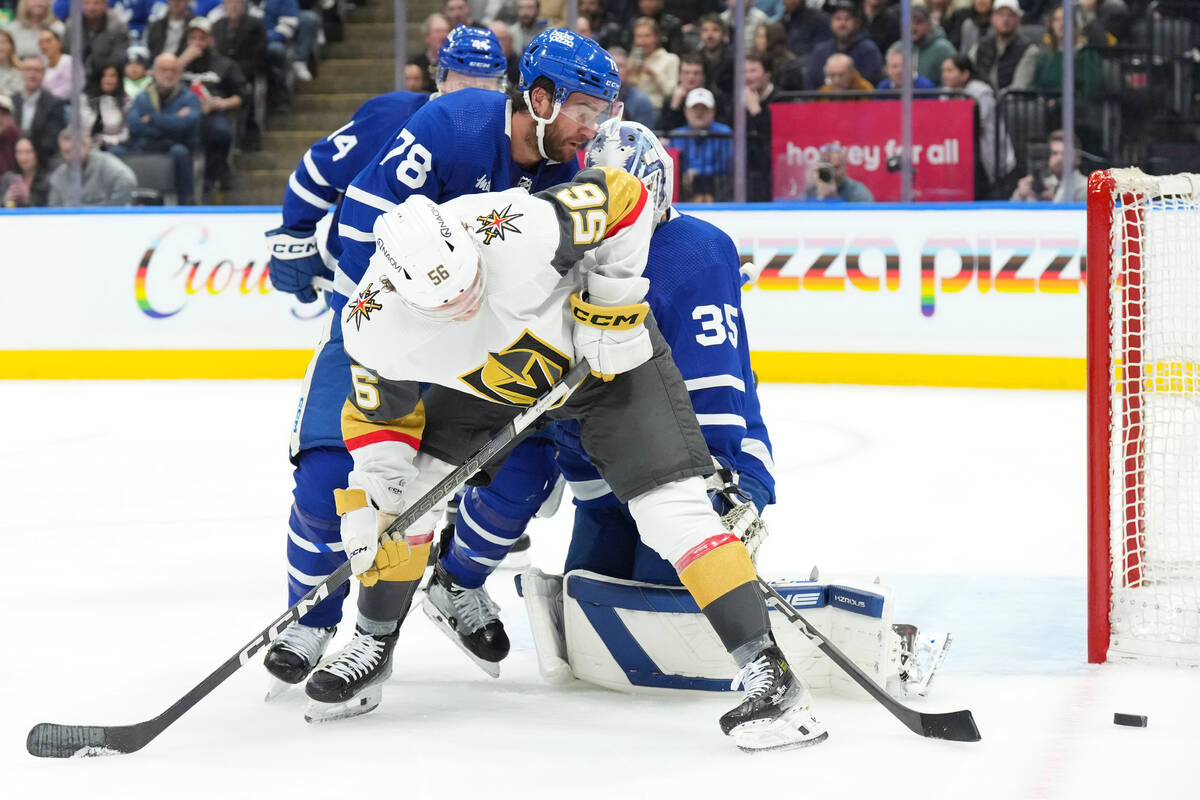 Vegas Golden Knights' Sheldon Rempal (56) battles for the puck in front of Toronto Maple Leafs ...
