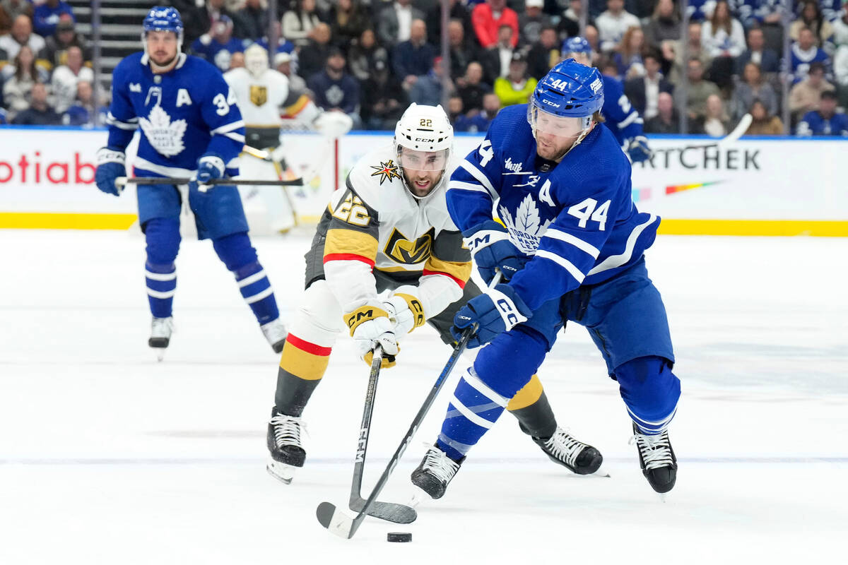 Toronto Maple Leafs' Morgan Rielly (44) battles for the puck with Vegas Golden Knights' Michael ...