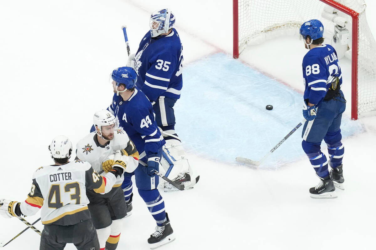 Vegas Golden Knights' Nicolas Roy, second left, celebrates with Paul Cotter (43) after scoring ...