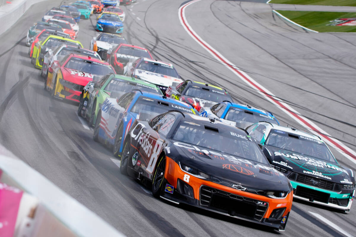 Kyle Busch (8) drives into Turn One during the NASCAR auto race at Atlanta Motor Speedway Sunda ...