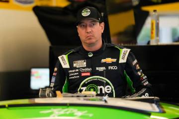 Kyle Busch stands by his car in the garage before a practice session for the NASCAR Daytona 500 ...