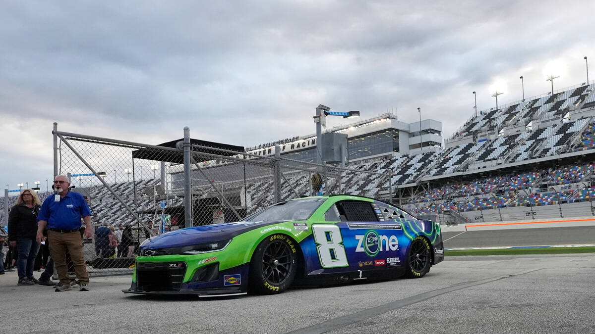 Kyle Busch returns to his garage for adjustments during a practice session for the NASCAR Dayto ...