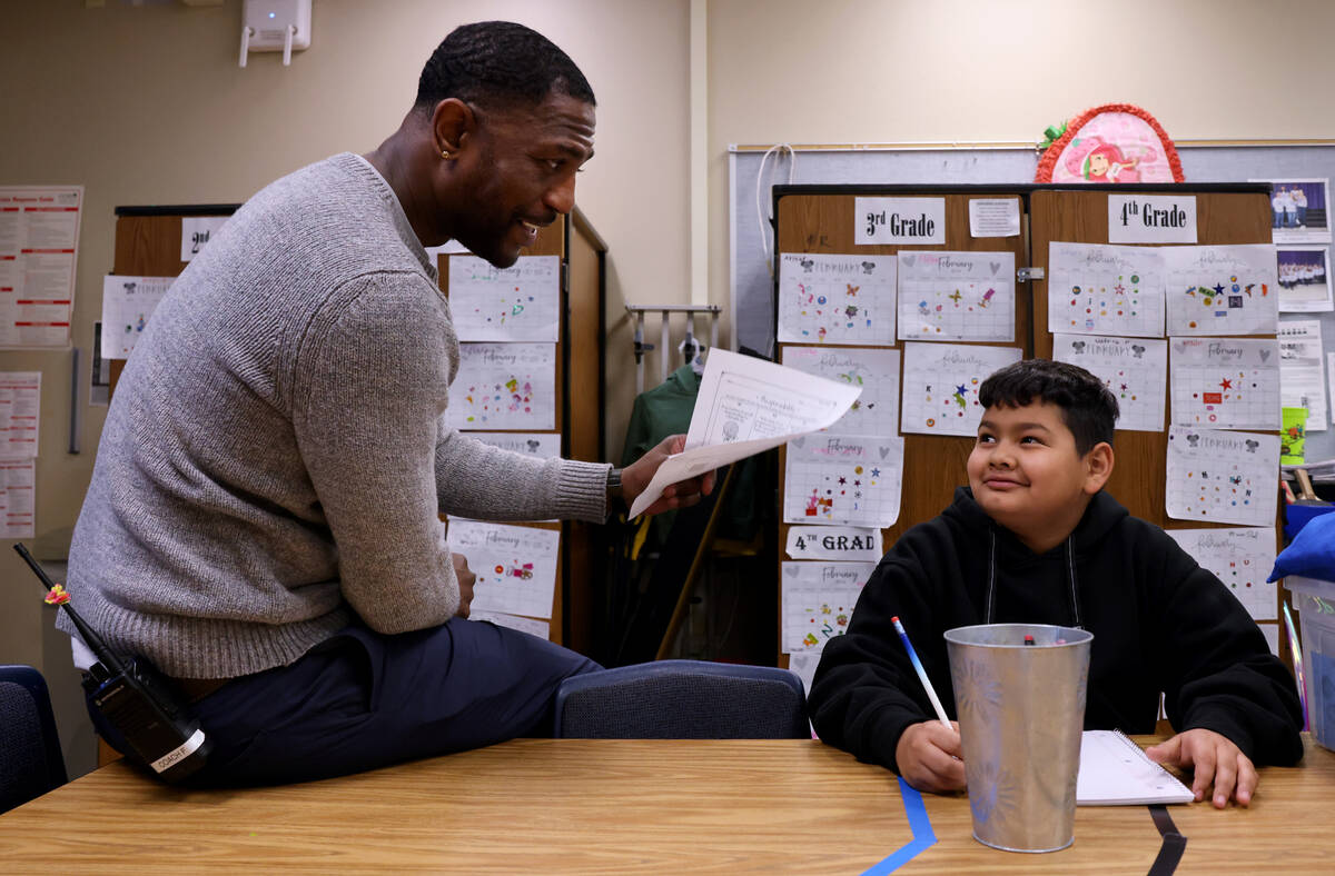 Communities In Schools of Southern Nevada Site Coordinator Raul Fention works with fifth grader ...