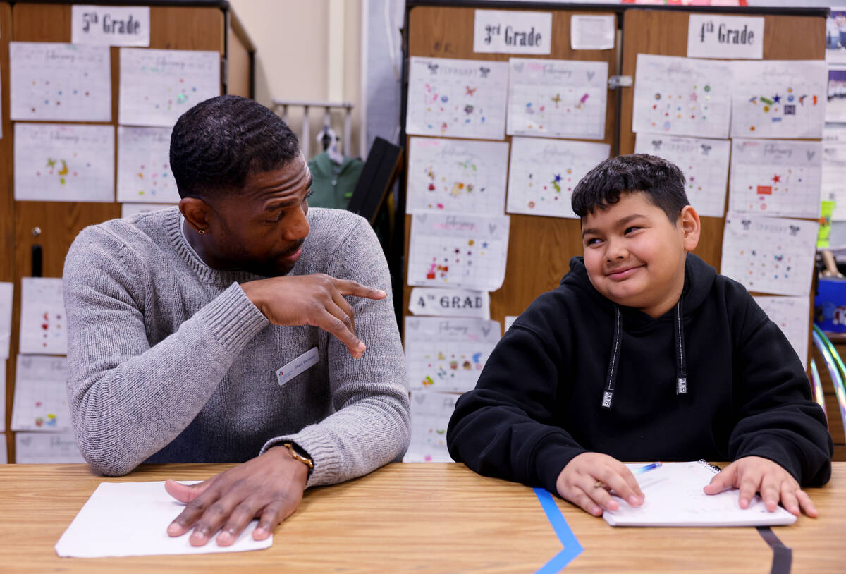 Communities In Schools of Southern Nevada Site Coordinator Raul Fention works with fifth grader ...