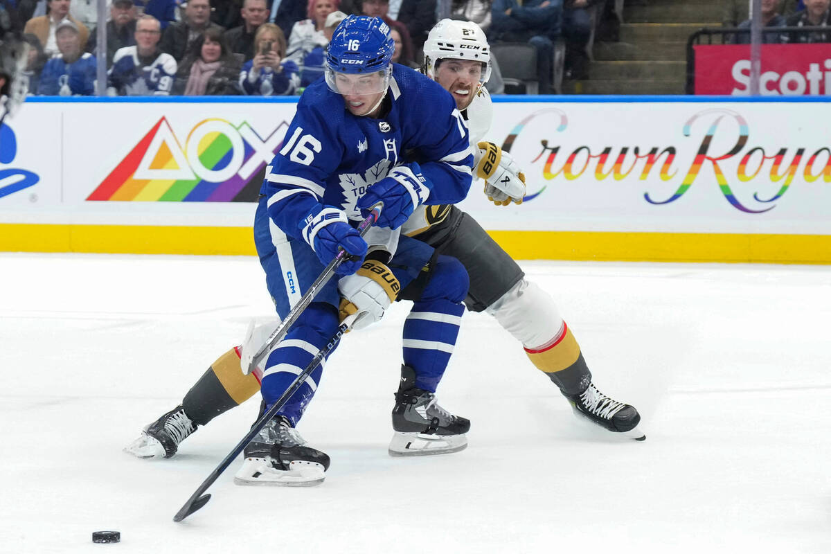 Toronto Maple Leafs' Mitchell Marner (16) protects the puck from Vegas Golden Knights' Shea The ...