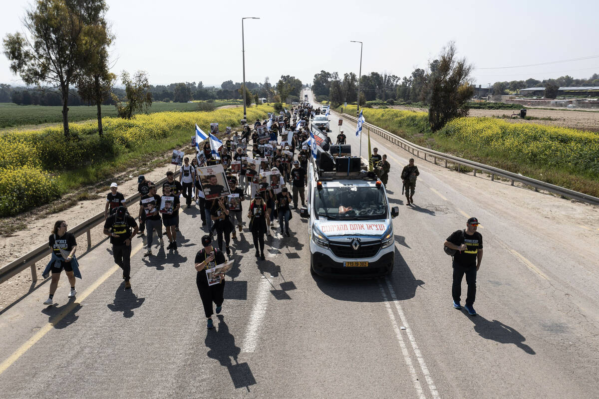 Families of hostages held by Hamas in the Gaza Strip march in southern Israel, as they head to ...