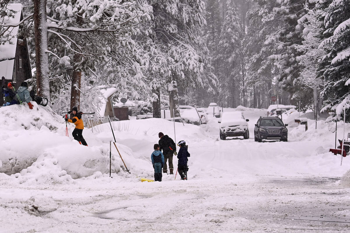 Children play on the snow off Donner Pass Road on Friday, March 1, 2024, in Truckee, Calif. The ...