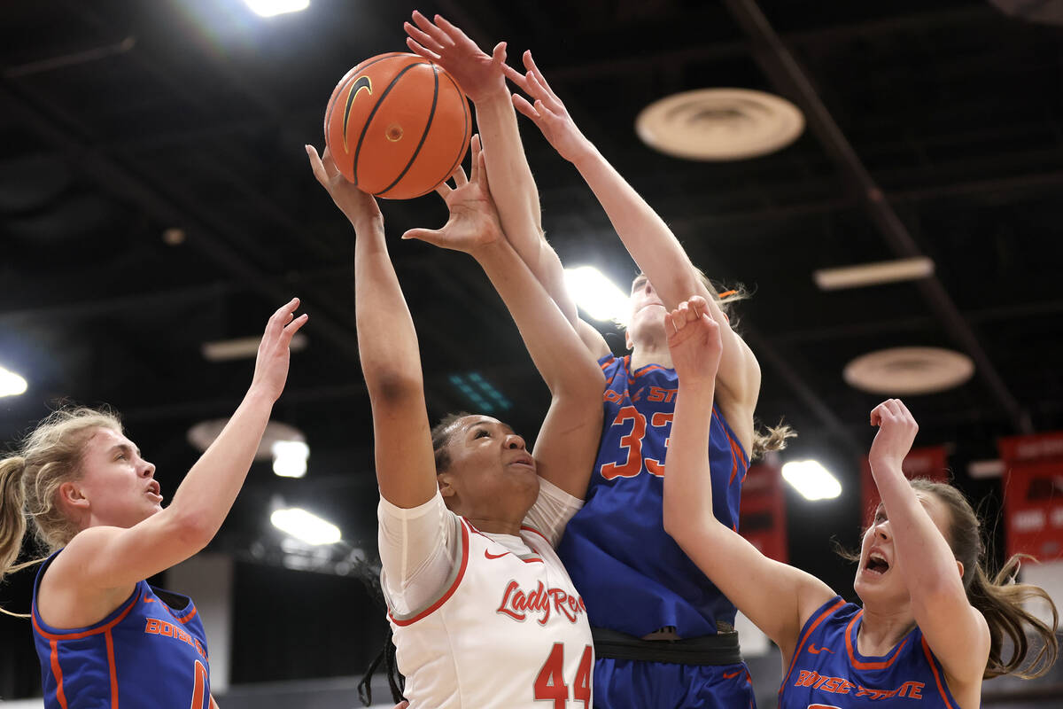 UNLV Lady Rebels forward Alyssa Brown (44) jumps for a rebound against Boise State Broncos forw ...