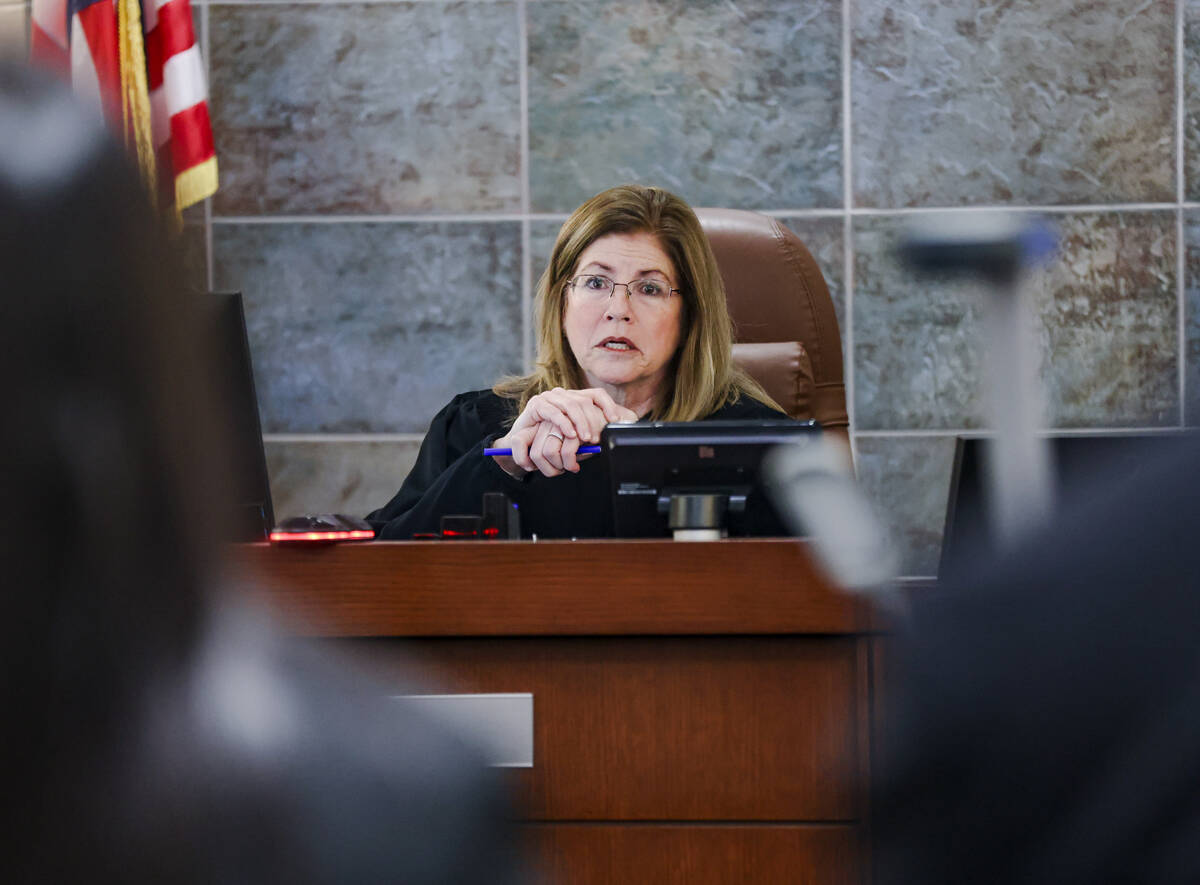District Court Judge Susan Johnson addresses the court during an arraignment for Deobra Redden, ...