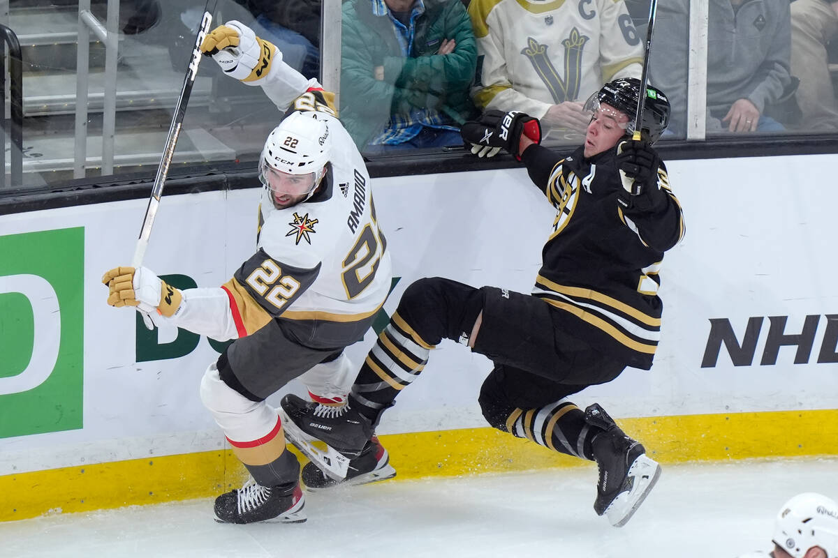 Vegas Golden Knights right wing Michael Amadio (22) and Boston Bruins defenseman Charlie McAvoy ...