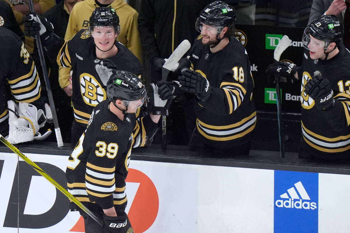 Boston Bruins center Morgan Geekie (39) celebrates with teammates after scoring in the second p ...