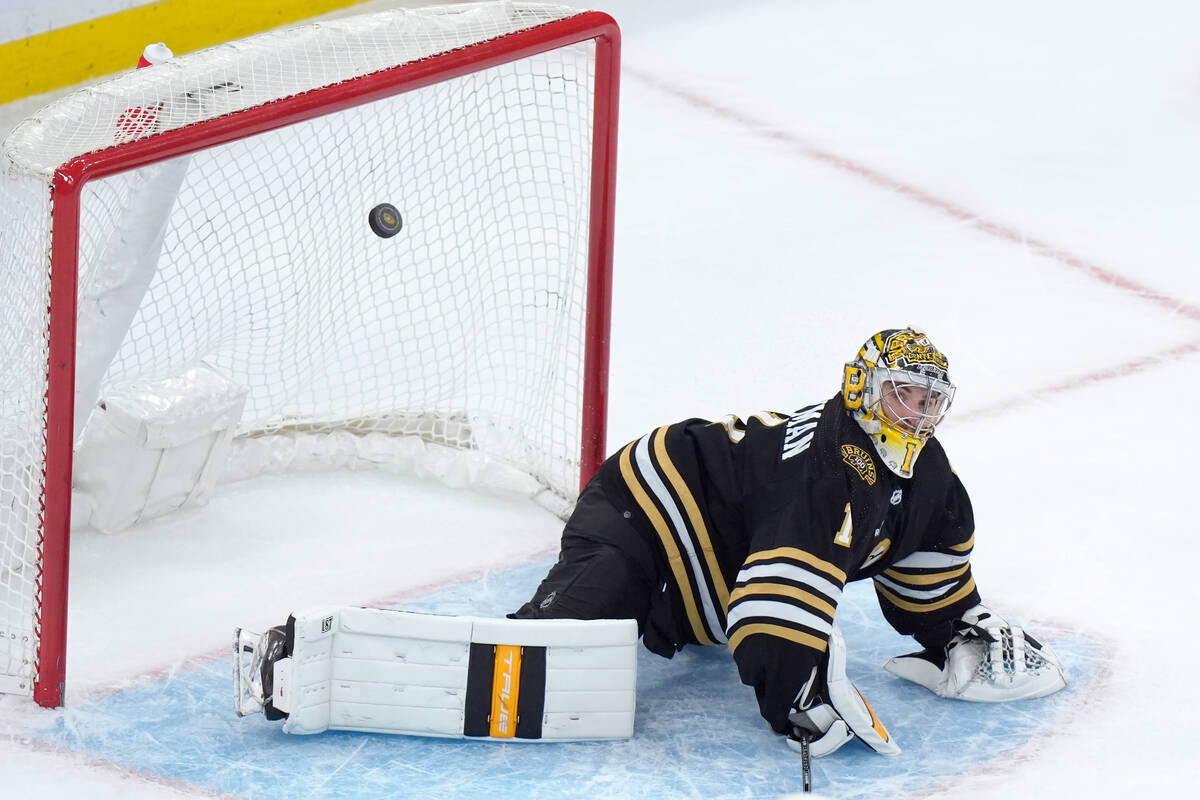Boston Bruins goaltender Jeremy Swayman (1) deflects a score-attempt by the Vegas Golden Knight ...