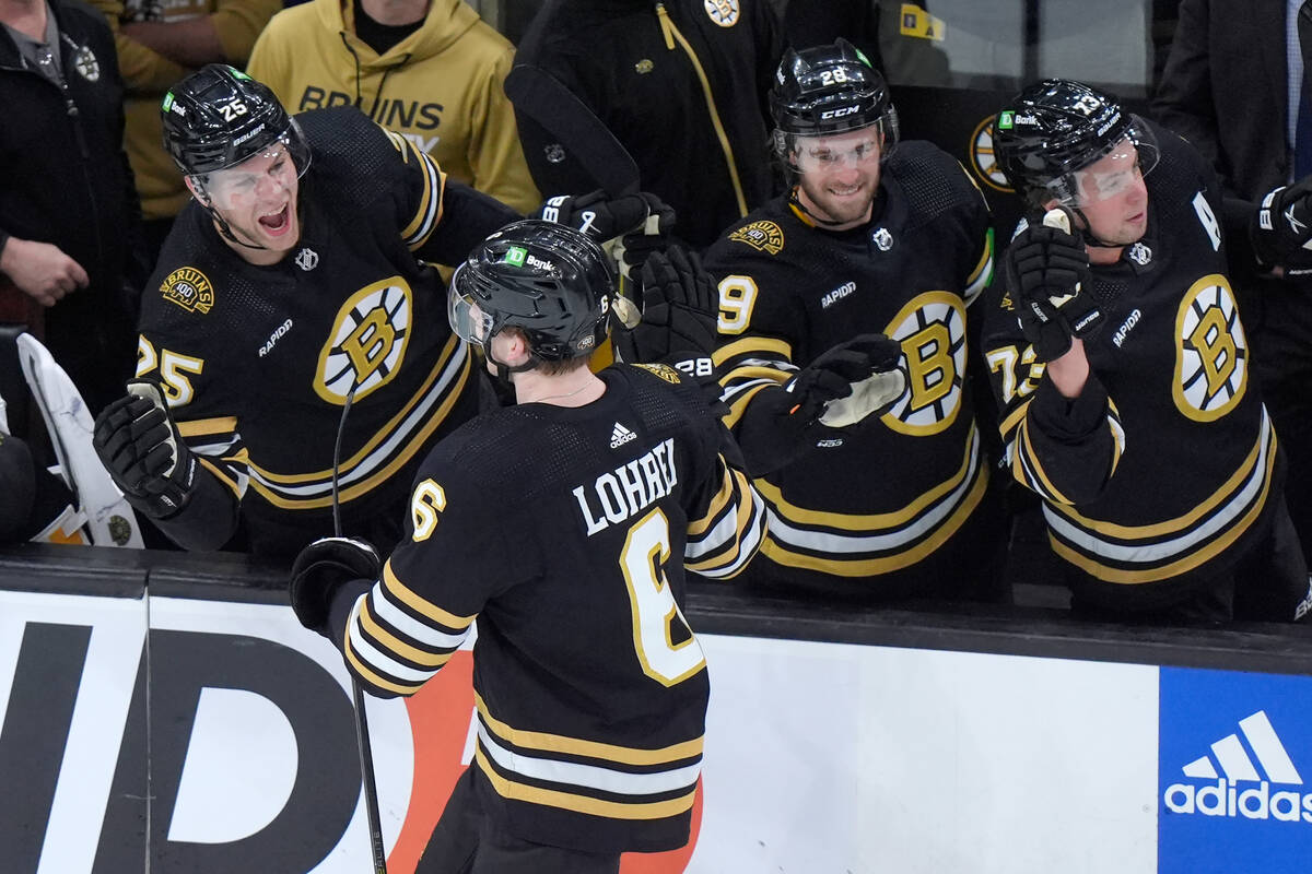 Boston Bruins defenseman Mason Lohrei (6) celebrates with teammates after scoring in the third ...
