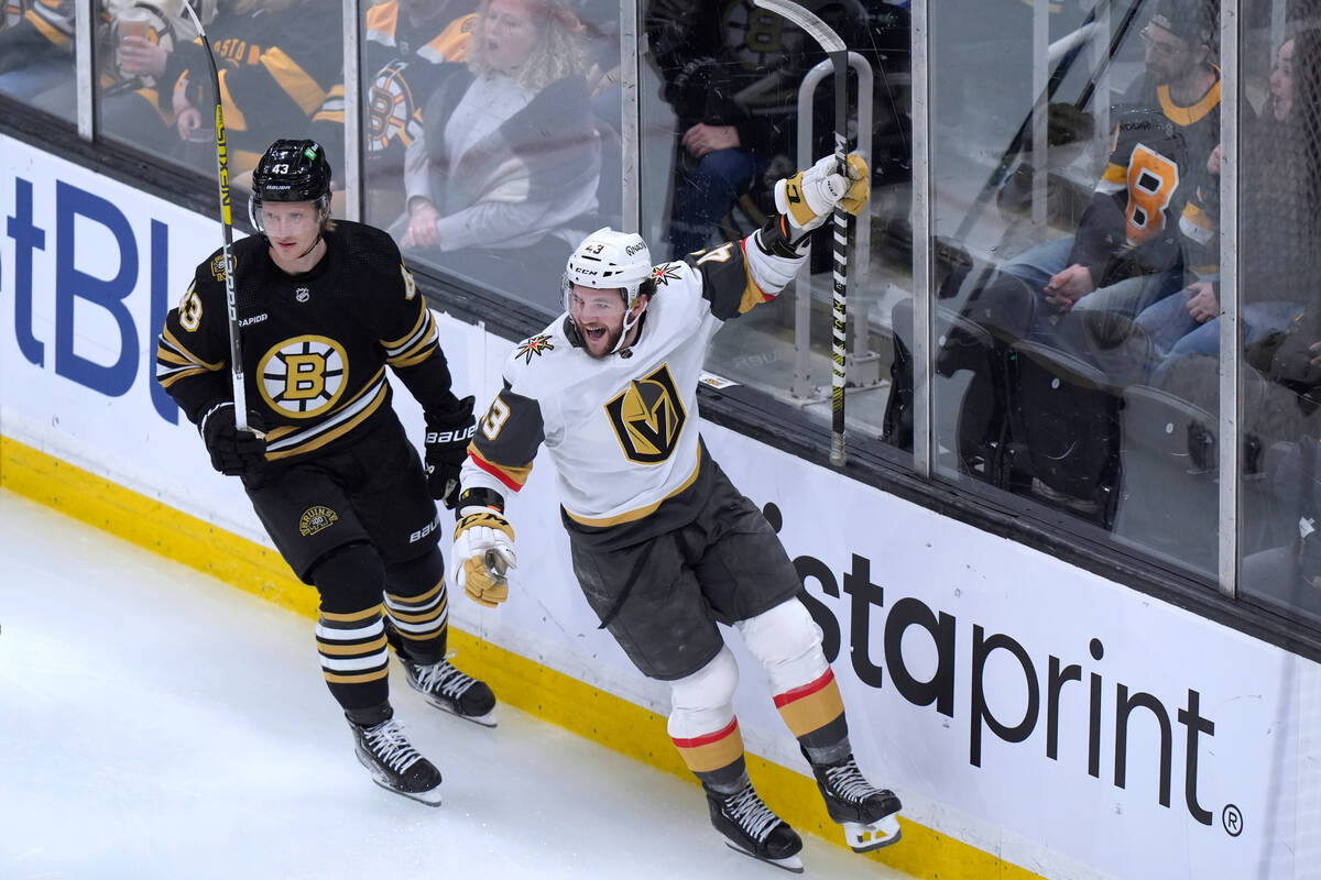 Vegas Golden Knights center Paul Cotter, right, celebrates in front of Boston Bruins left wing ...