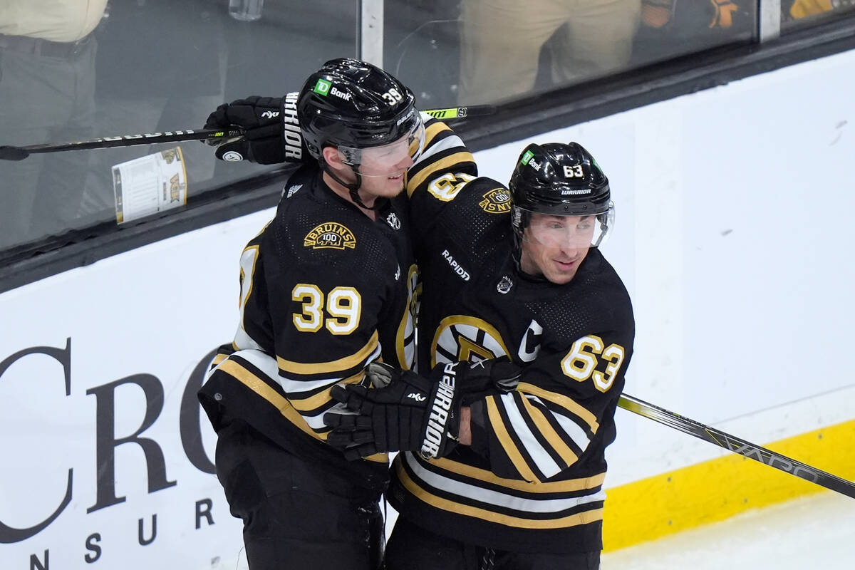 Boston Bruins center Morgan Geekie (39) celebrates with left wing Brad Marchand (63) after scor ...
