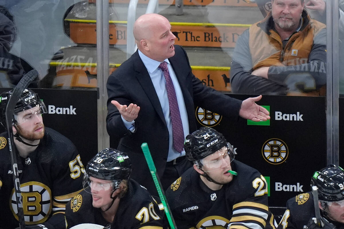 Boston Bruins head coach Jim Montgomery, top center, shouts from behind the bench in the second ...