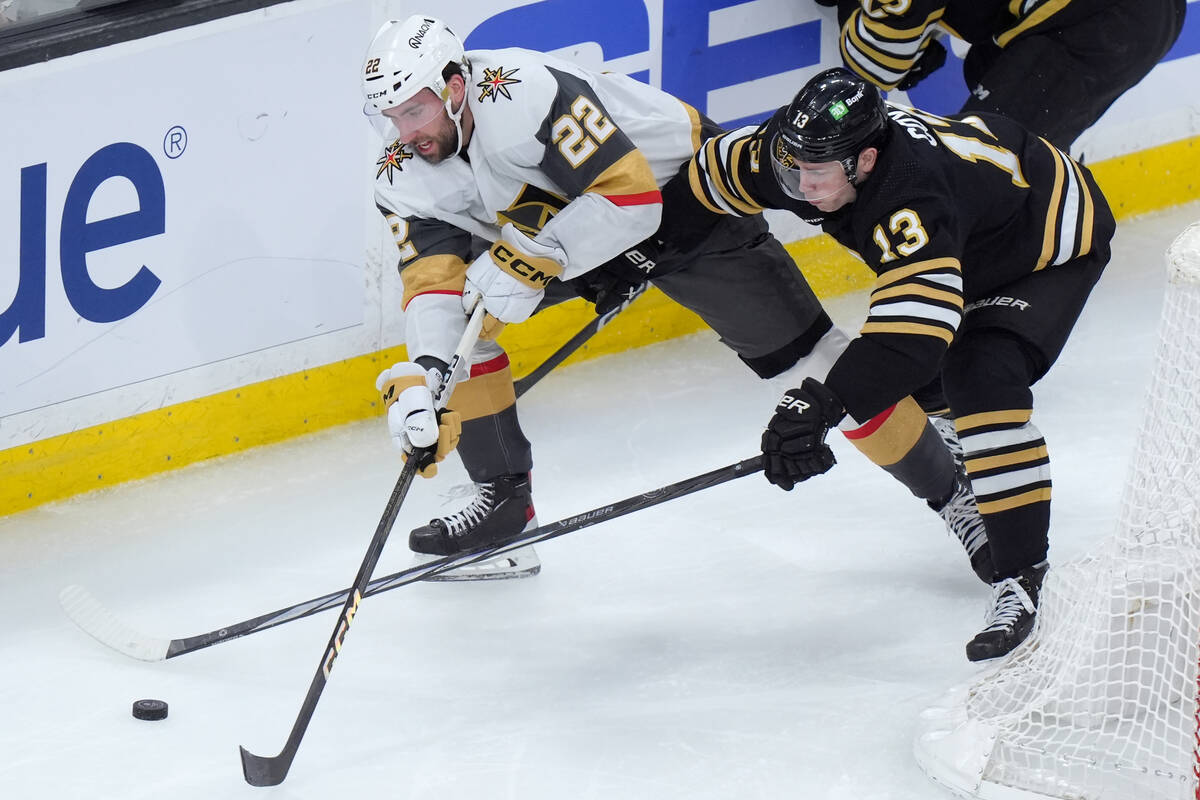Vegas Golden Knights right wing Michael Amadio (22) and Boston Bruins center Charlie Coyle (13) ...