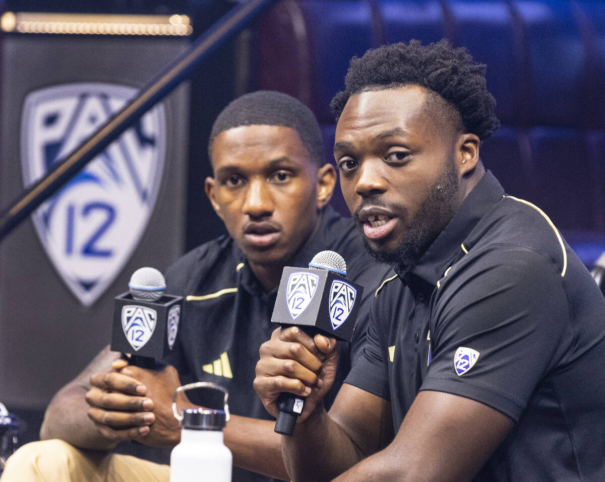 Washington Huskies quarterback Michael Penix Jr., left, listens as linebacker Edefuan Ulofoshio ...