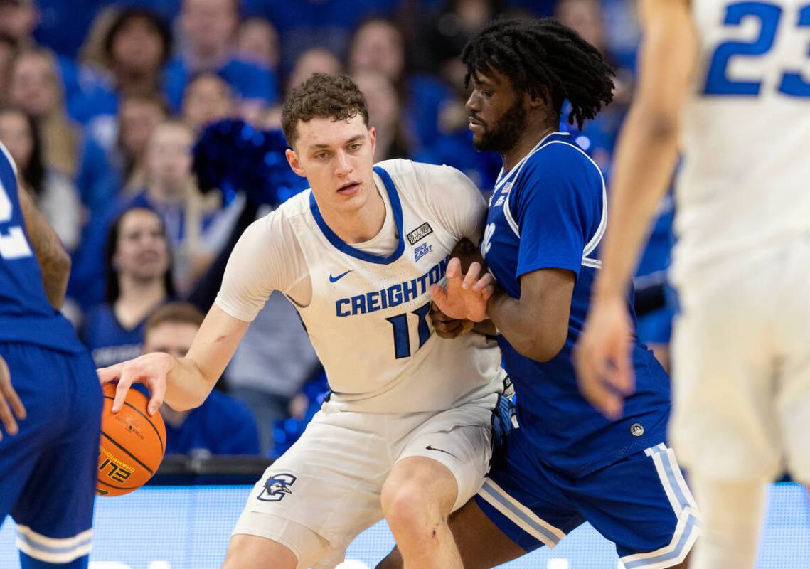 Creighton's Ryan Kalkbrenner, left, drives against Seton Hall's Jaden Bediako during the first ...