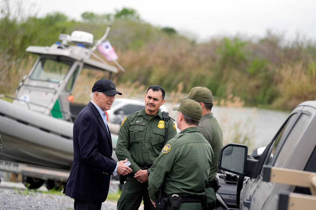 President Joe Biden talks with the U.S. Border Patrol, as he looks over the southern border, Th ...