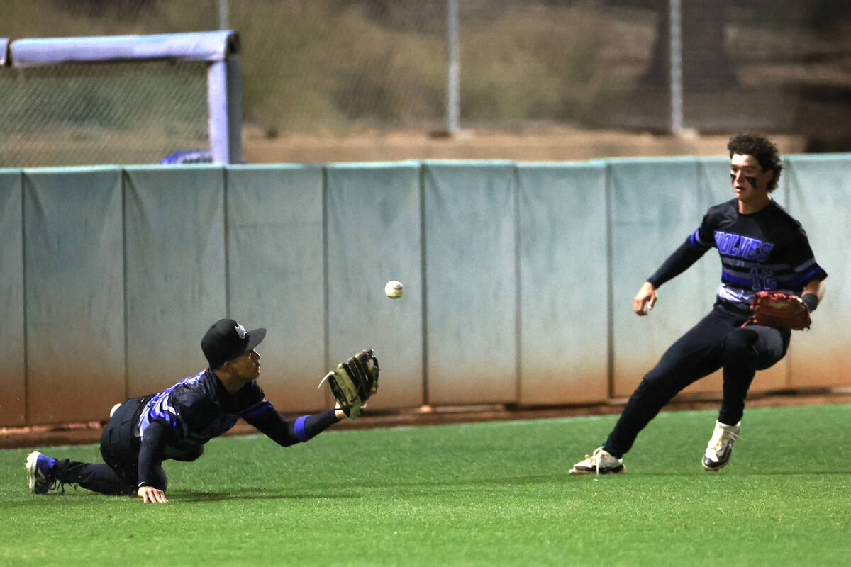 Basic short stop Ty Southisene, left, misses a catch while outfielder Connor Long runs to assis ...