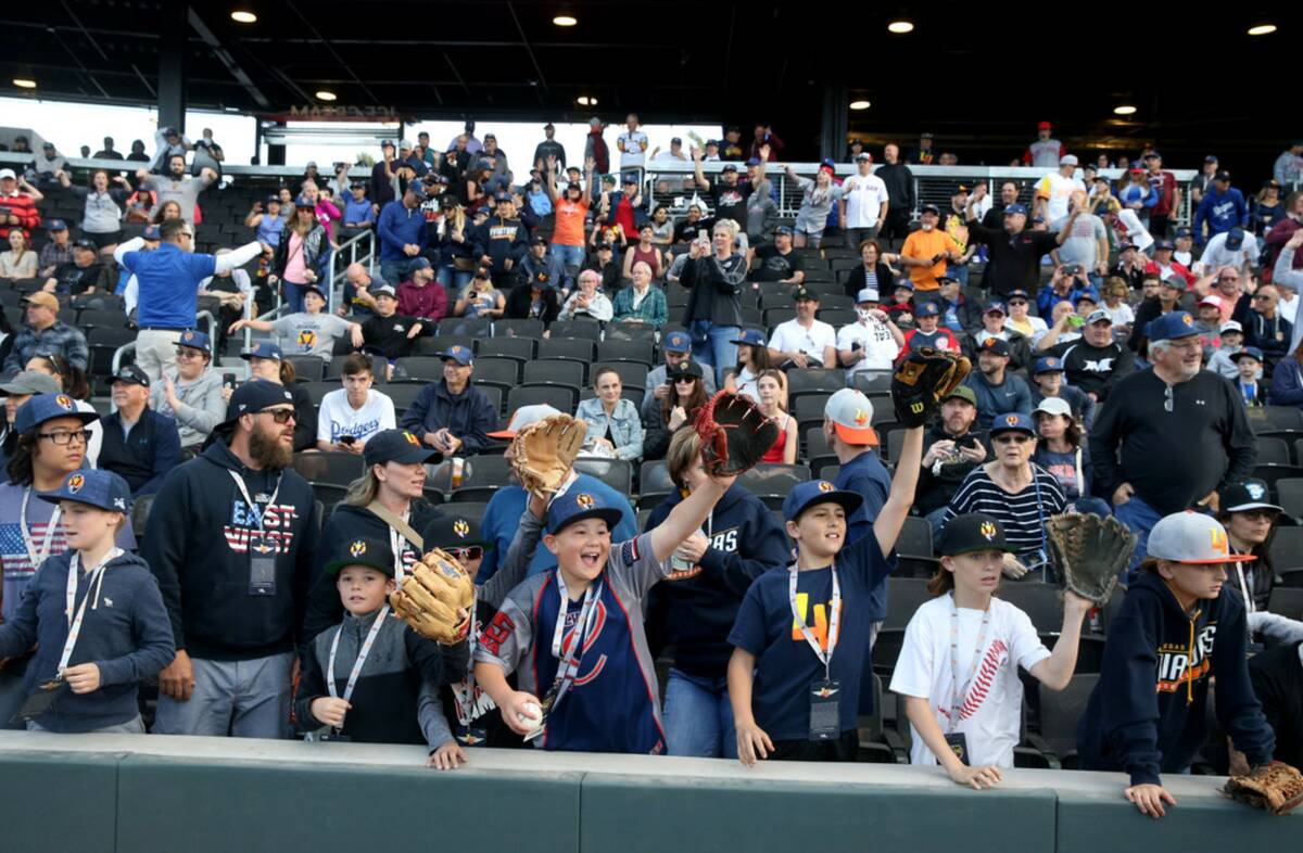 Fans hope for a ball from the players during opening night for the Las Vegas Aviators at Las Ve ...