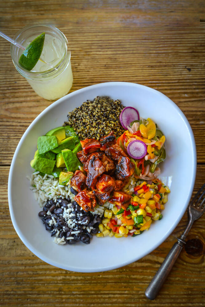 The Coop Bowl, with mesquite-smoked chicken, cilantro lime rice and charred corn relish, from t ...