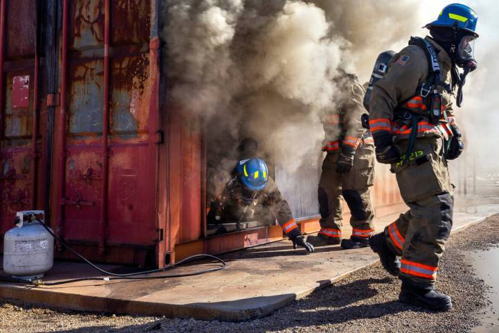 Clark County Fire Department recruits exit a smoky trailer during a live fire training in 2023. ...