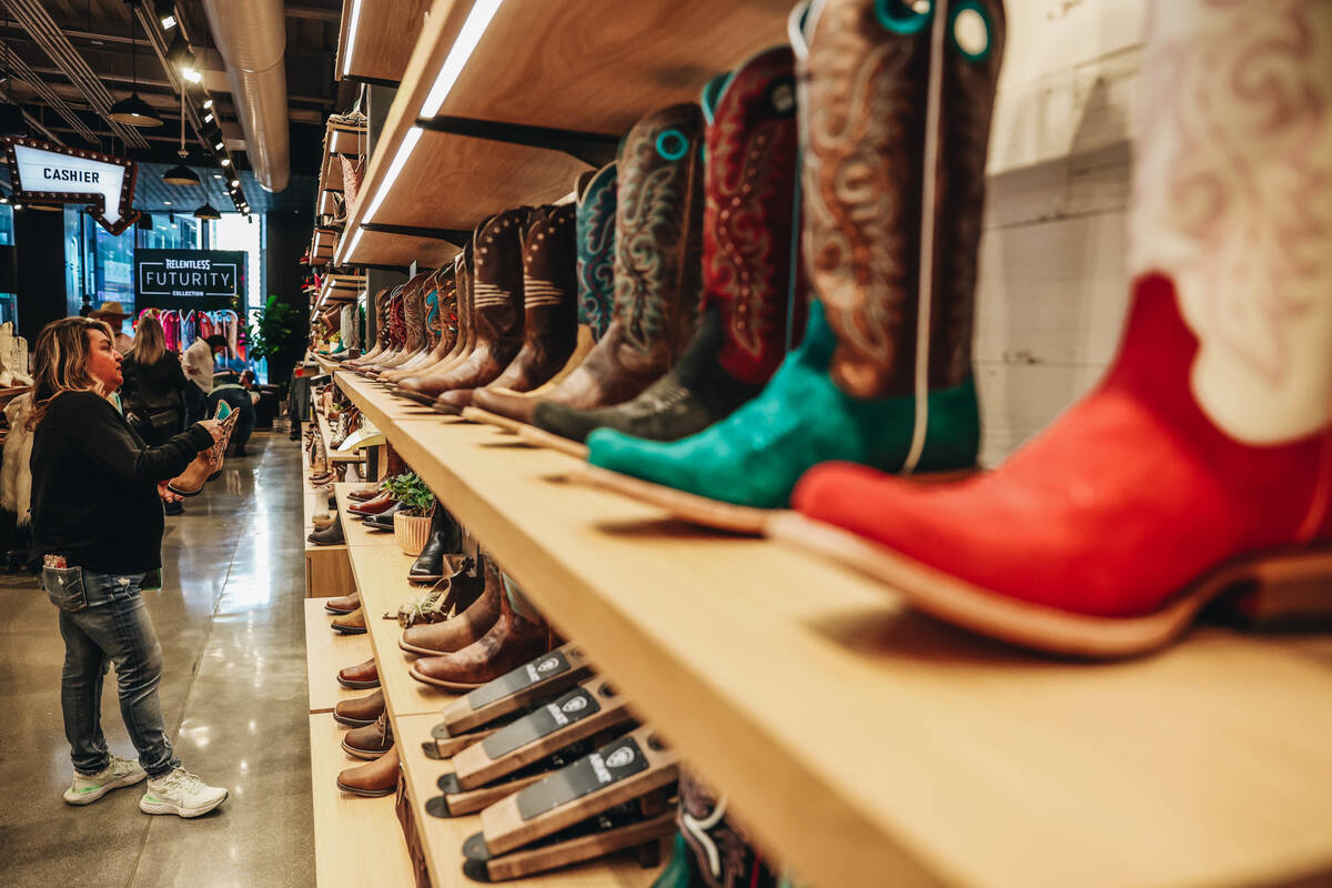 A customer shops at the new Ariat shop at 63 Las Vegas is seen on Thursday, Feb. 29, 2024, in L ...