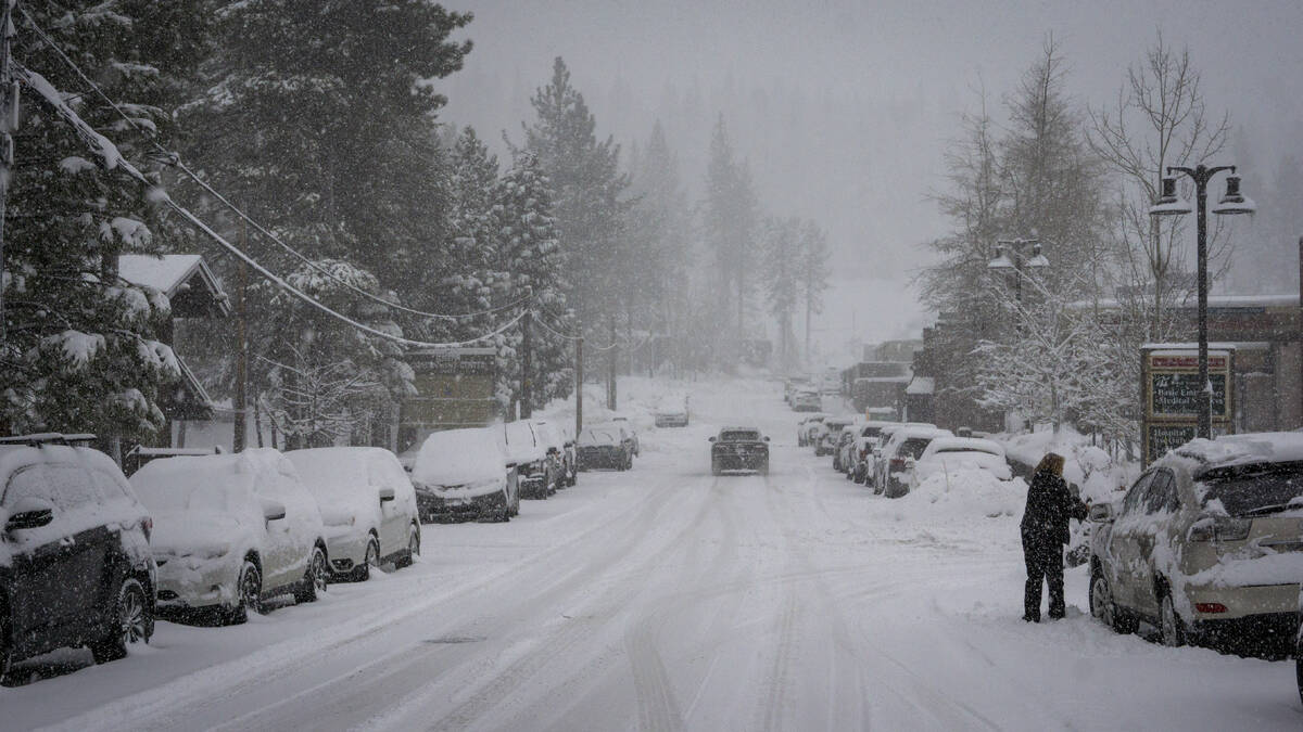 Parked vehicles are covered in snow during a storm Friday, March 1, 2024, in Truckee, Calif. (A ...