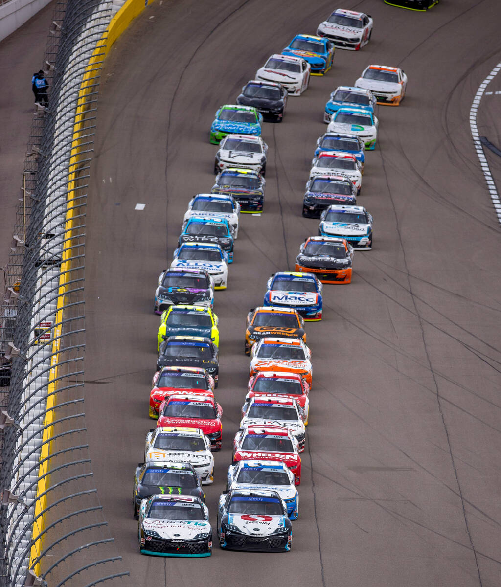 (LtoR) Drivers Chandler Smith, #81, and John Hunter Nemechek, 20, battle in the front of the pa ...