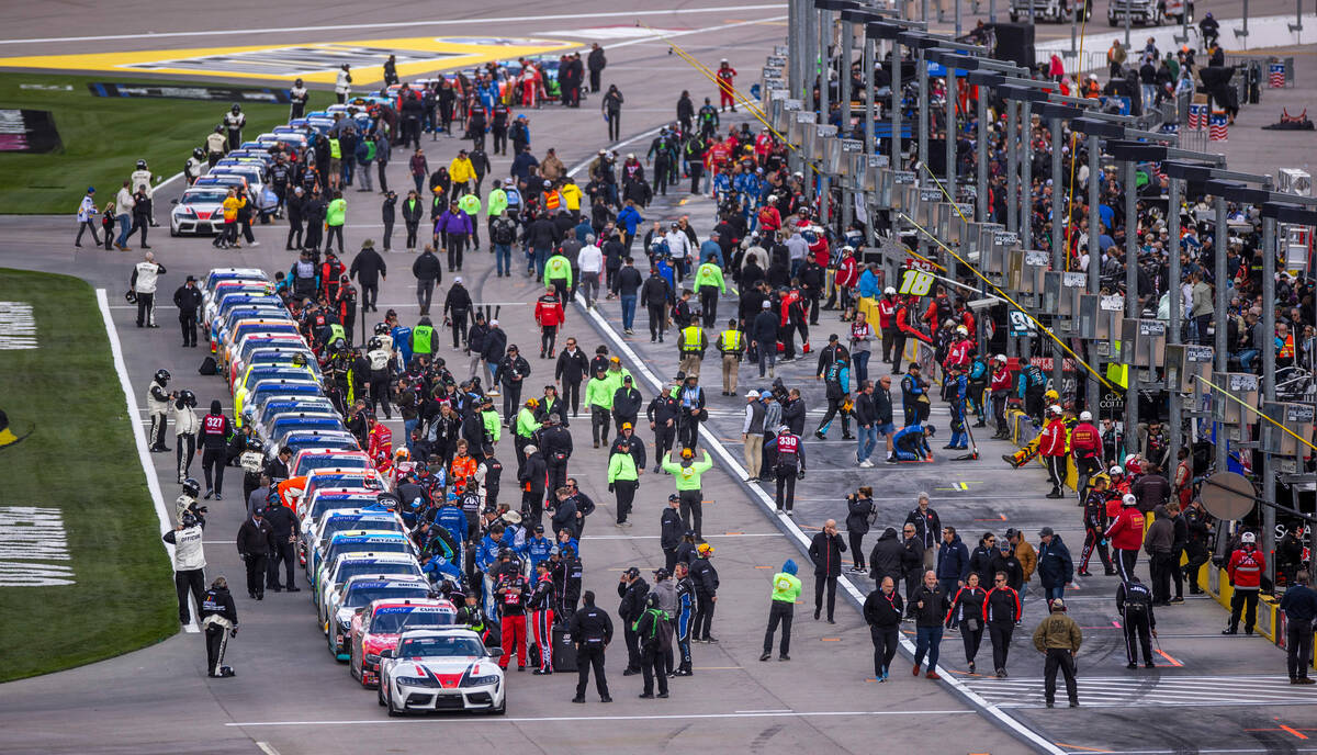 Cars, their teams and others await the start during the LiUNA NASCAR Xfinity Series race at the ...