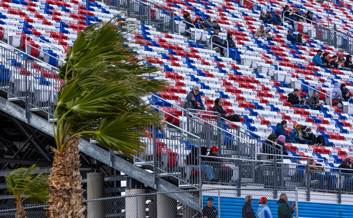The wind blows hard as fans watch the action during the LiUNA NASCAR Xfinity Series race at the ...