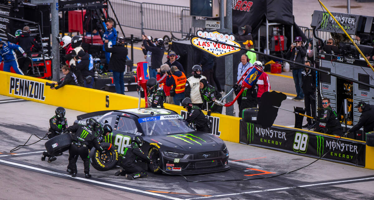 The pit crew changes tires and adds gas as driver Riley Herbst, 98, competes during the LiUNA N ...